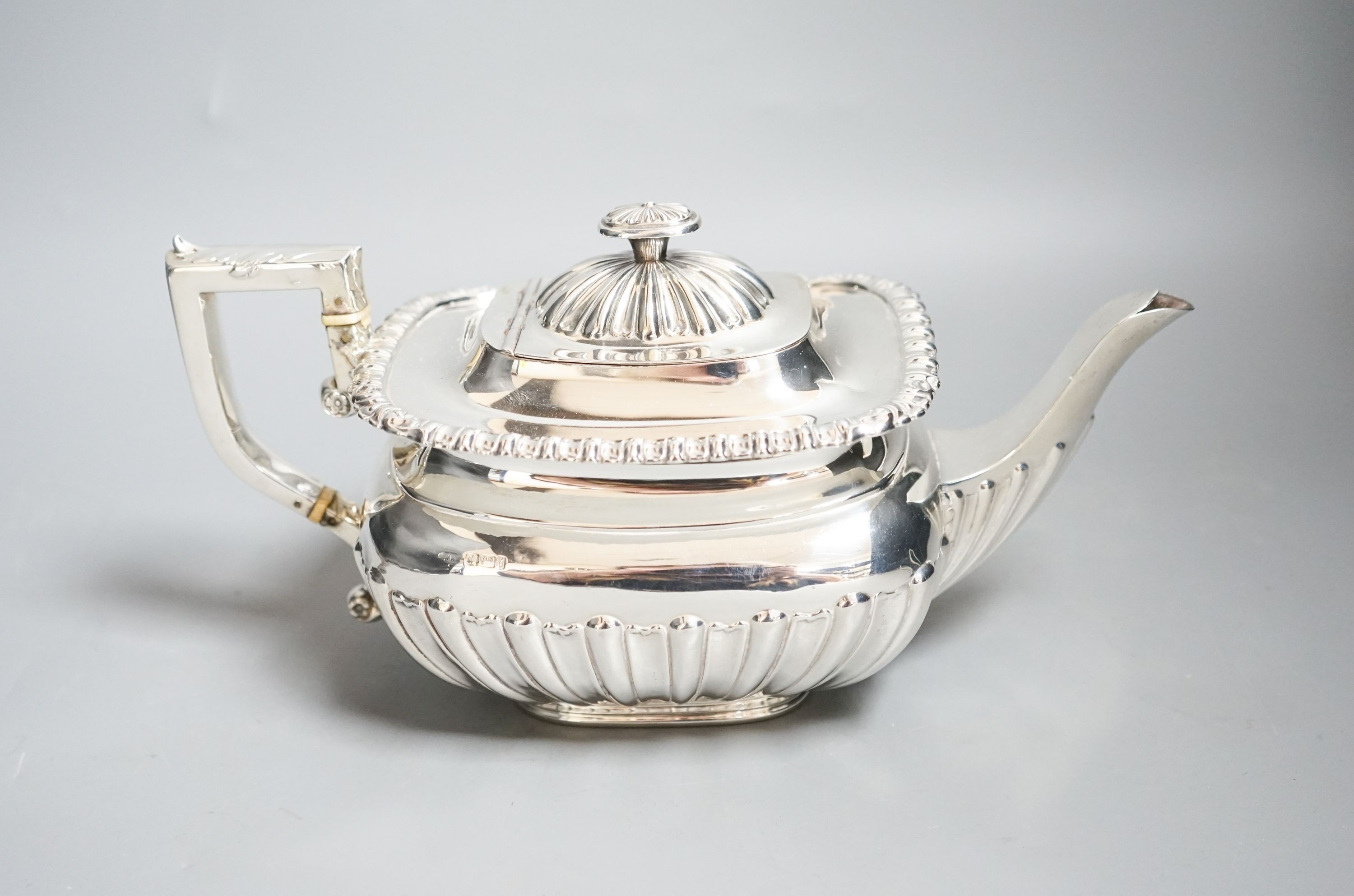 An Edwardian demi-fluted silver teapot, Sheffield, 1901, gross 22.5oz.